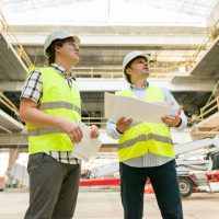 Two business builder people at construction site